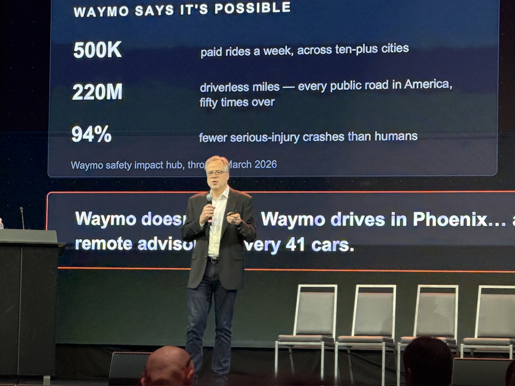 Bill Nussey on stage at RoboGeorgia 2026 with the Waymo reliability data